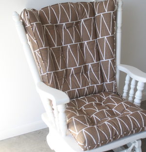 Wingback style glider replacement cushions in brown fabric with white triangles