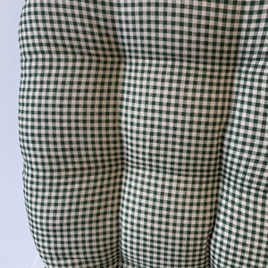 close up of fir green gingham fabric glider rocker replacement cushions on a glider rocking chair