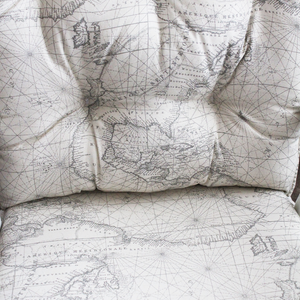 closeup of a set of glider replacement cushions with a foam seat upgrade in map fabric