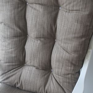 closeup of glider rocker replacement cushions in solid brown fabric