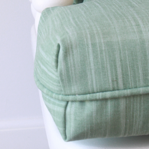closeup of solid sage green T cushion for glider rocker