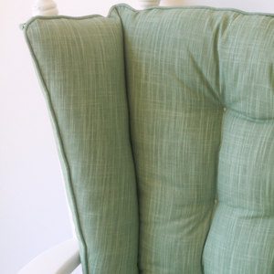 closeup of solid sage green wingback glider rocker replacement cushion